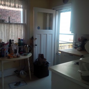 Before: The corner with door and window and zero storage